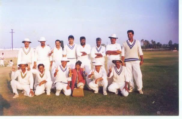 A team in whites posed on a ground in an old photograph
