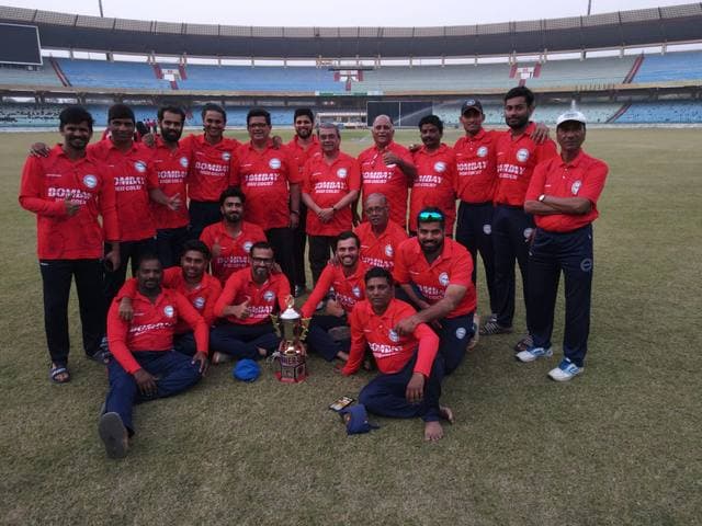 A team in red kit with trophies in a stadium