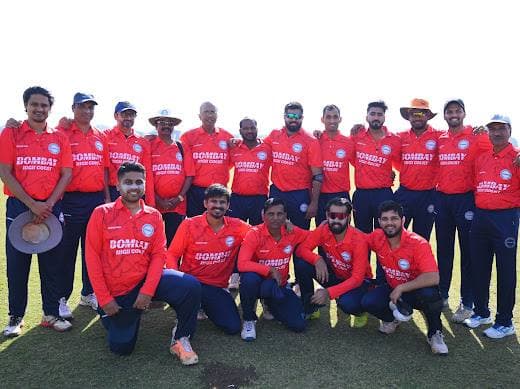 A team in red shirts, some kneeling in front