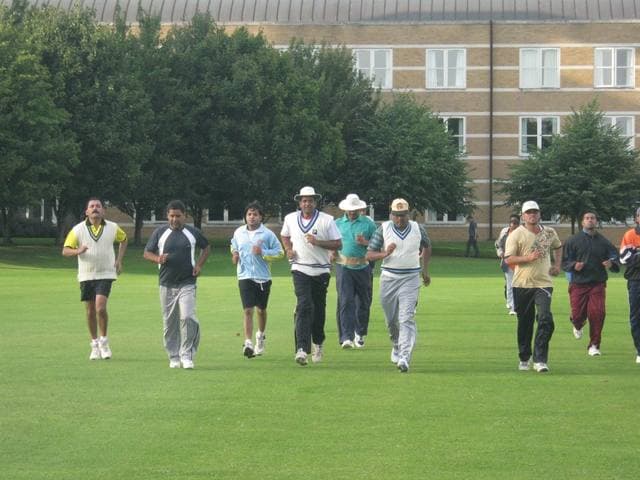 A group jogging across a green lawn