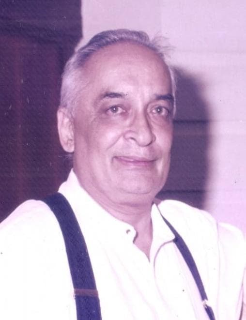 The late Adv. Vijay Tulpule in a white shirt and suspenders