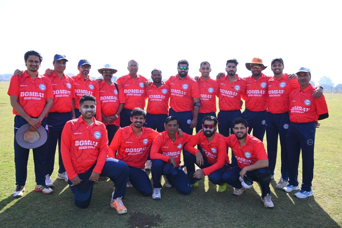 A team in red shirts lined up on a ground